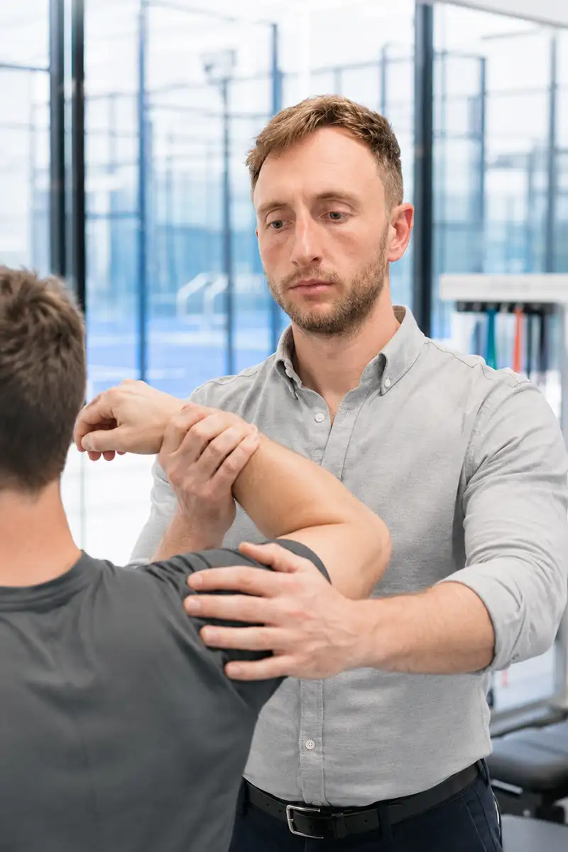 David Ruth carrying out a physiotherapy assessment at Dorset Sports Physio, Advantage Padel, Christchurch